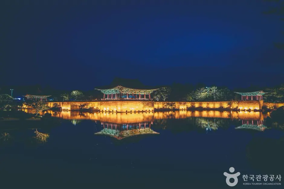 Illuminated pavilions reflected across Wolji Pond at night in Gyeongju