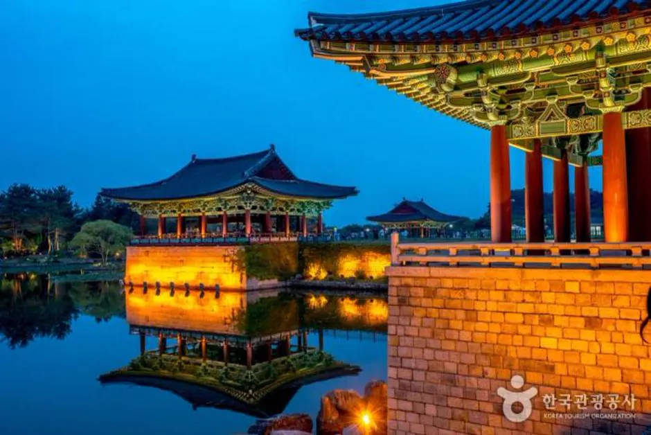 Close view of Donggung Palace pavilions reflected in Wolji Pond during blue hour